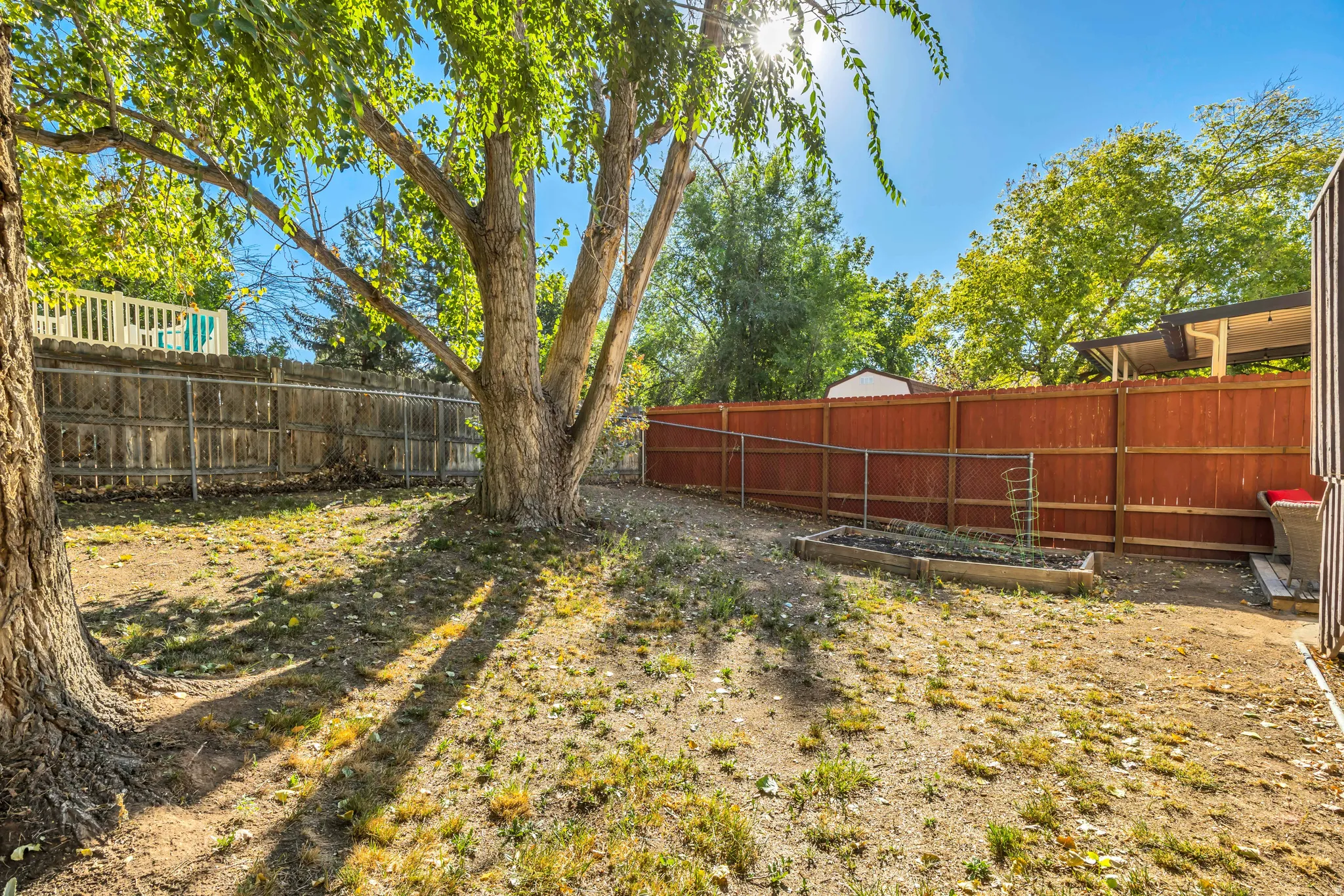 Fenced backyard featuring a vegetable garden