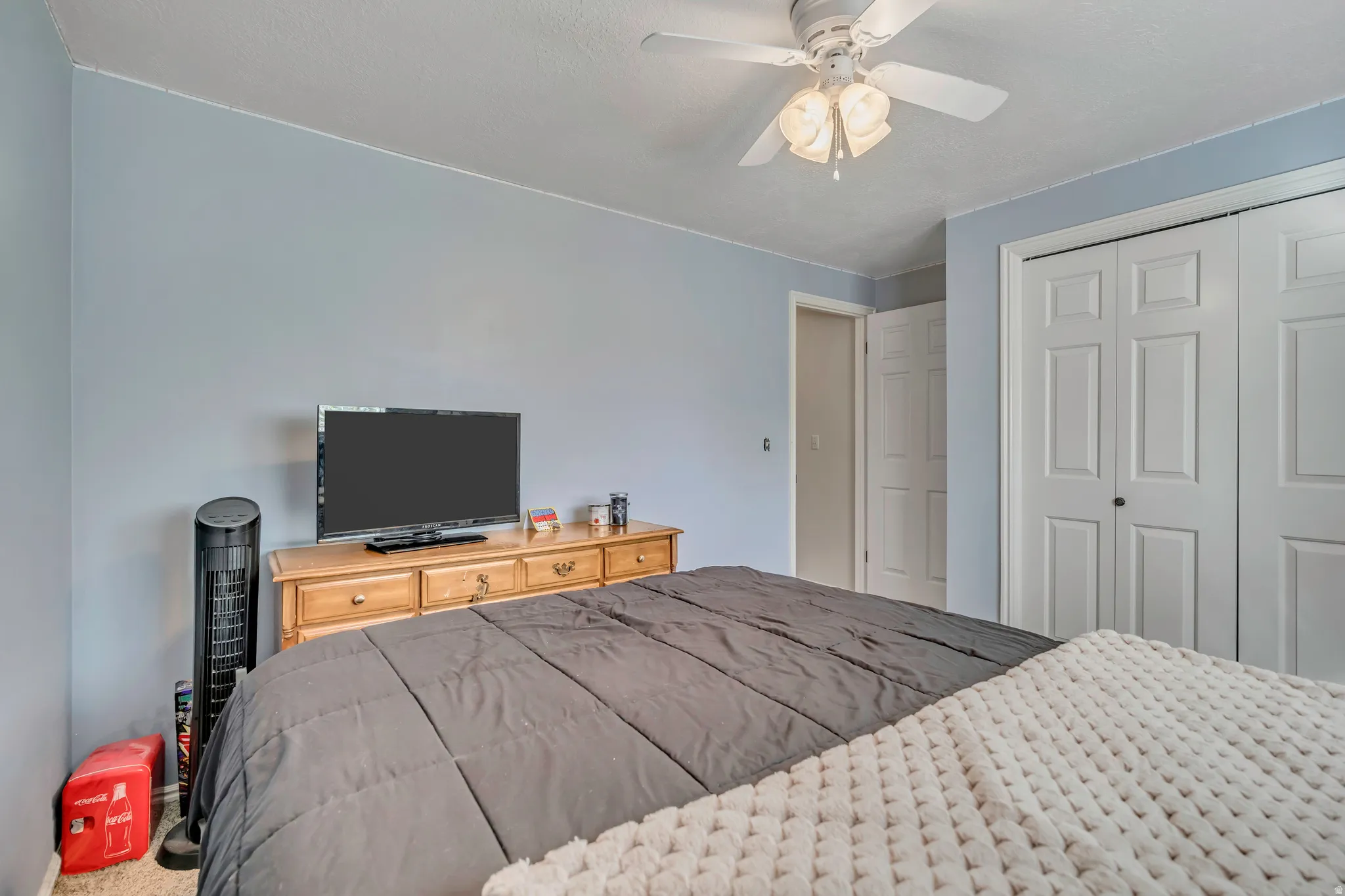 Bedroom featuring a closet, a ceiling fan, and carpet