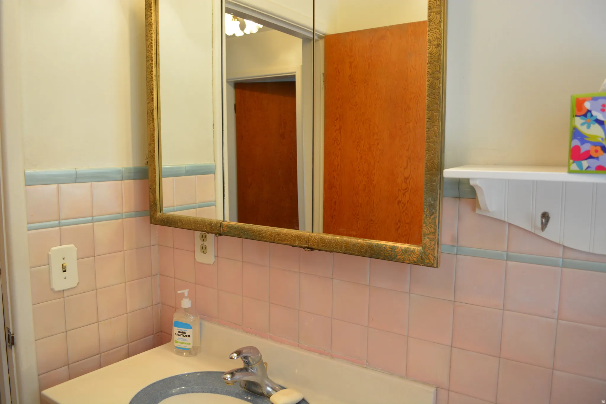 Bathroom featuring vanity and tile walls
