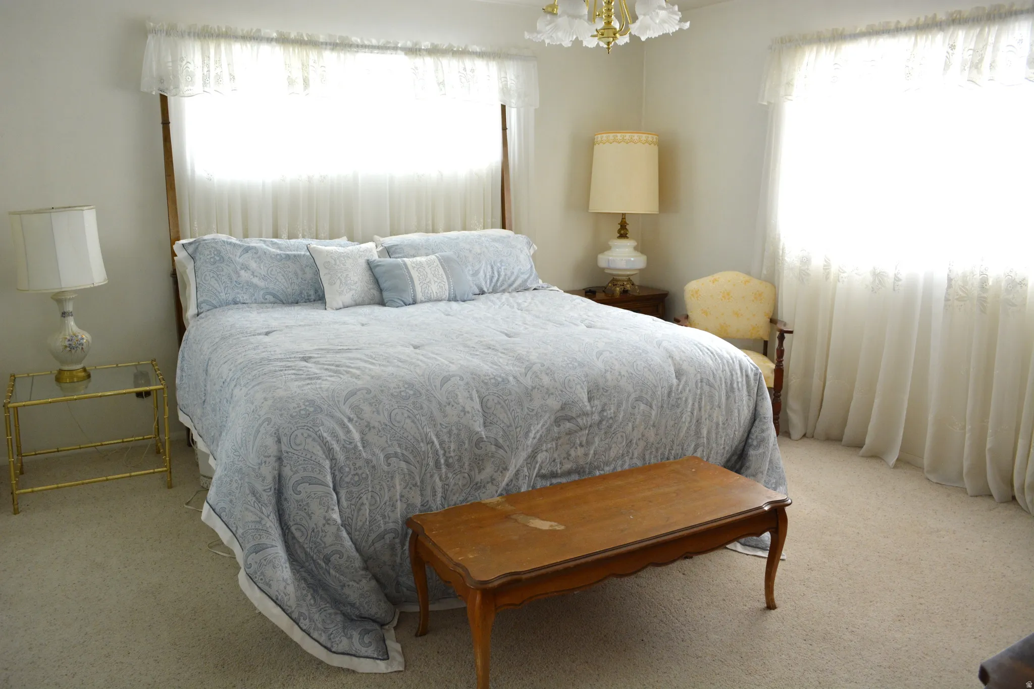 Bedroom with light carpet and multiple windows