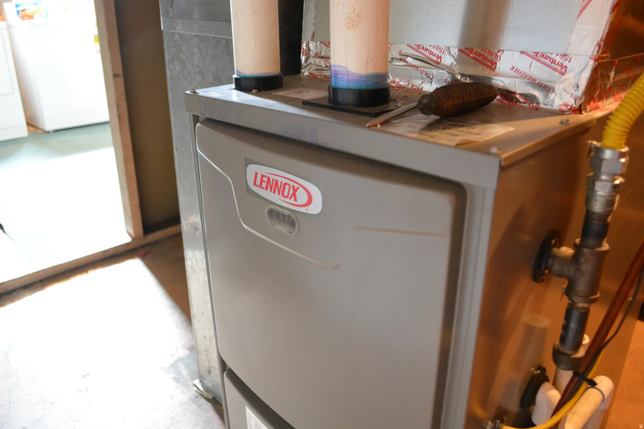 Utilities featuring washer / clothes dryer, heating unit, and a heating unit