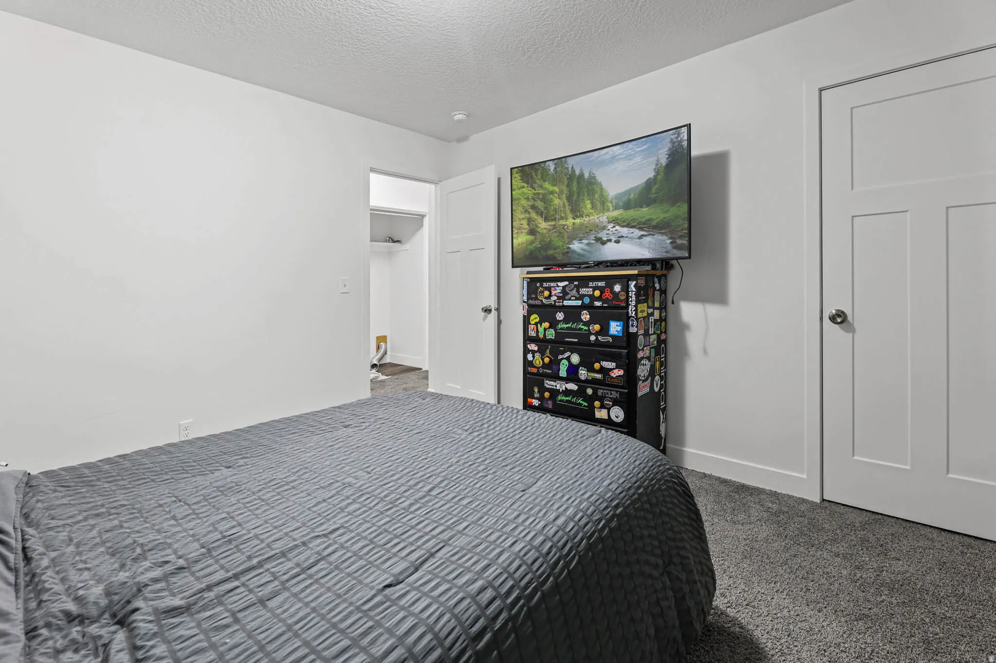 Bedroom featuring carpet floors and a textured ceiling
