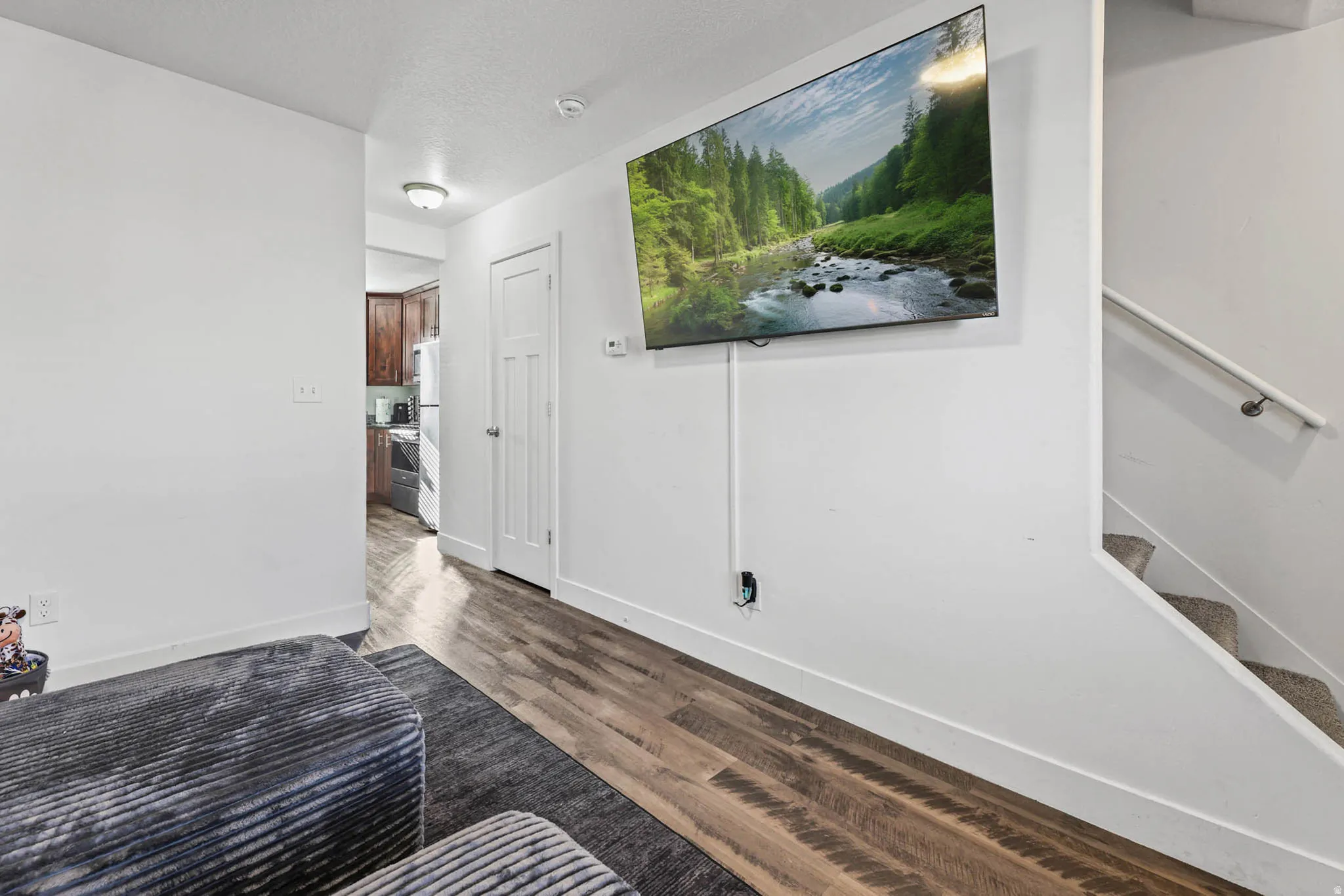 Bedroom with dark wood-style floors and a textured ceiling