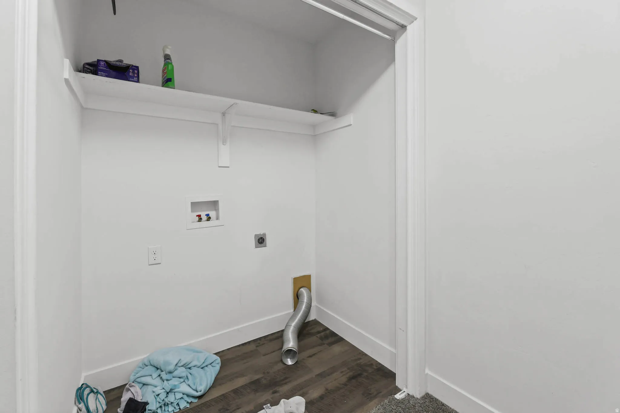 Laundry area featuring hookup for an electric dryer, washer hookup, and dark wood-style flooring