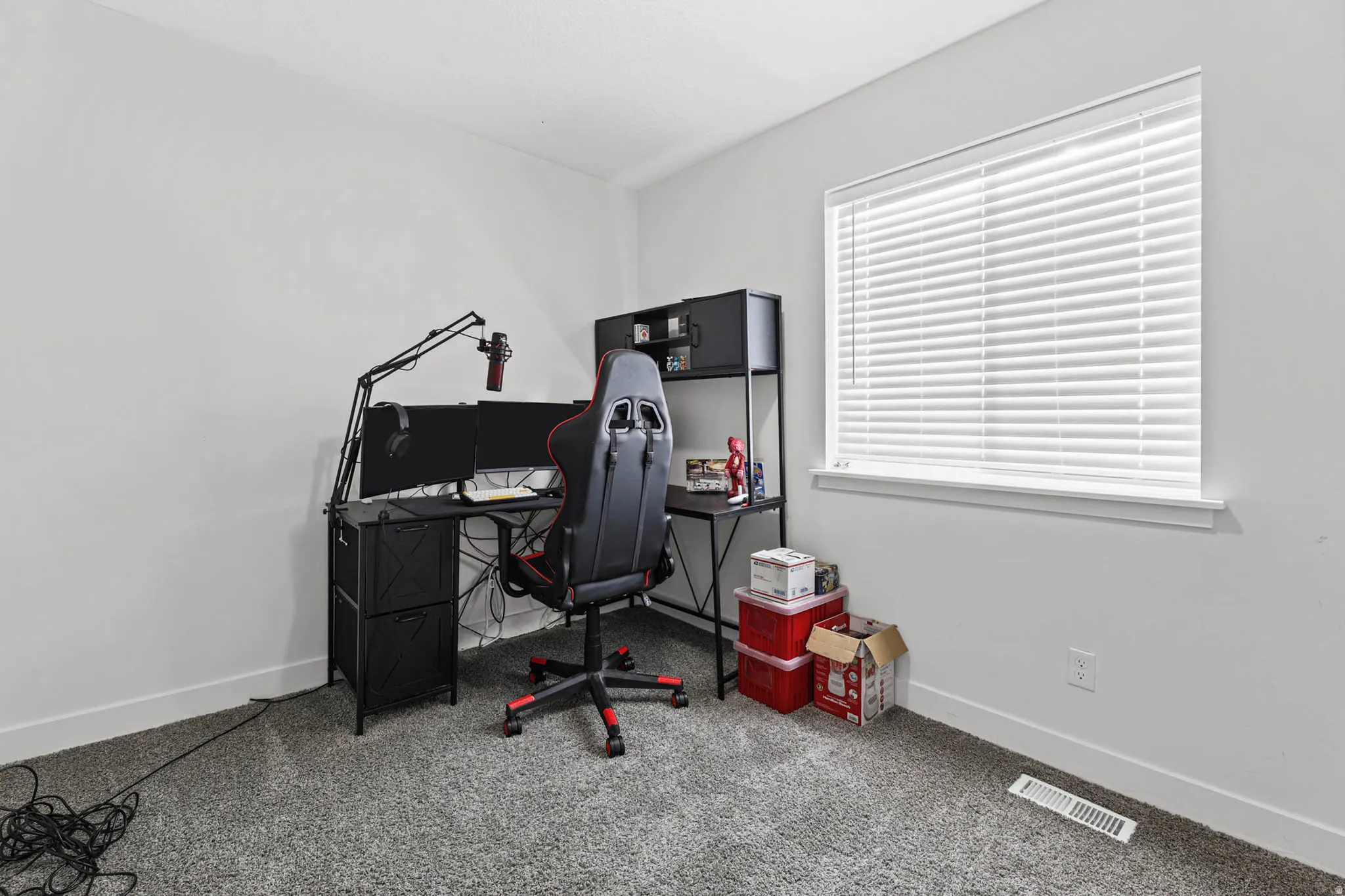 Office area featuring light carpet and baseboards