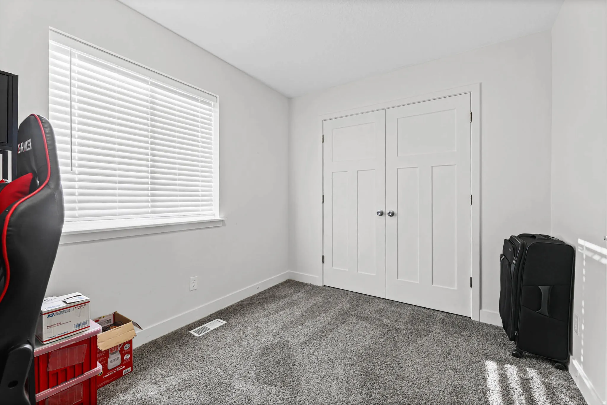 Office space with dark colored carpet and baseboards