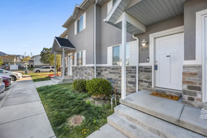 Property entrance featuring stone siding and stucco siding