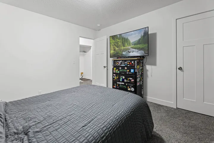 Bedroom featuring carpet floors and a textured ceiling