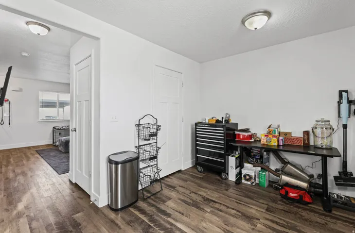 Miscellaneous room with dark wood-style floors and a textured ceiling