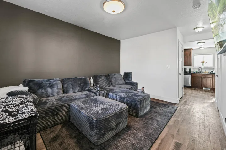 Living room featuring dark wood finished floors and a textured ceiling