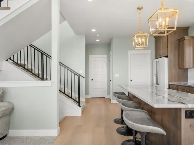 Kitchen island featuring a substantial stone-finish countertop and integrated seating
