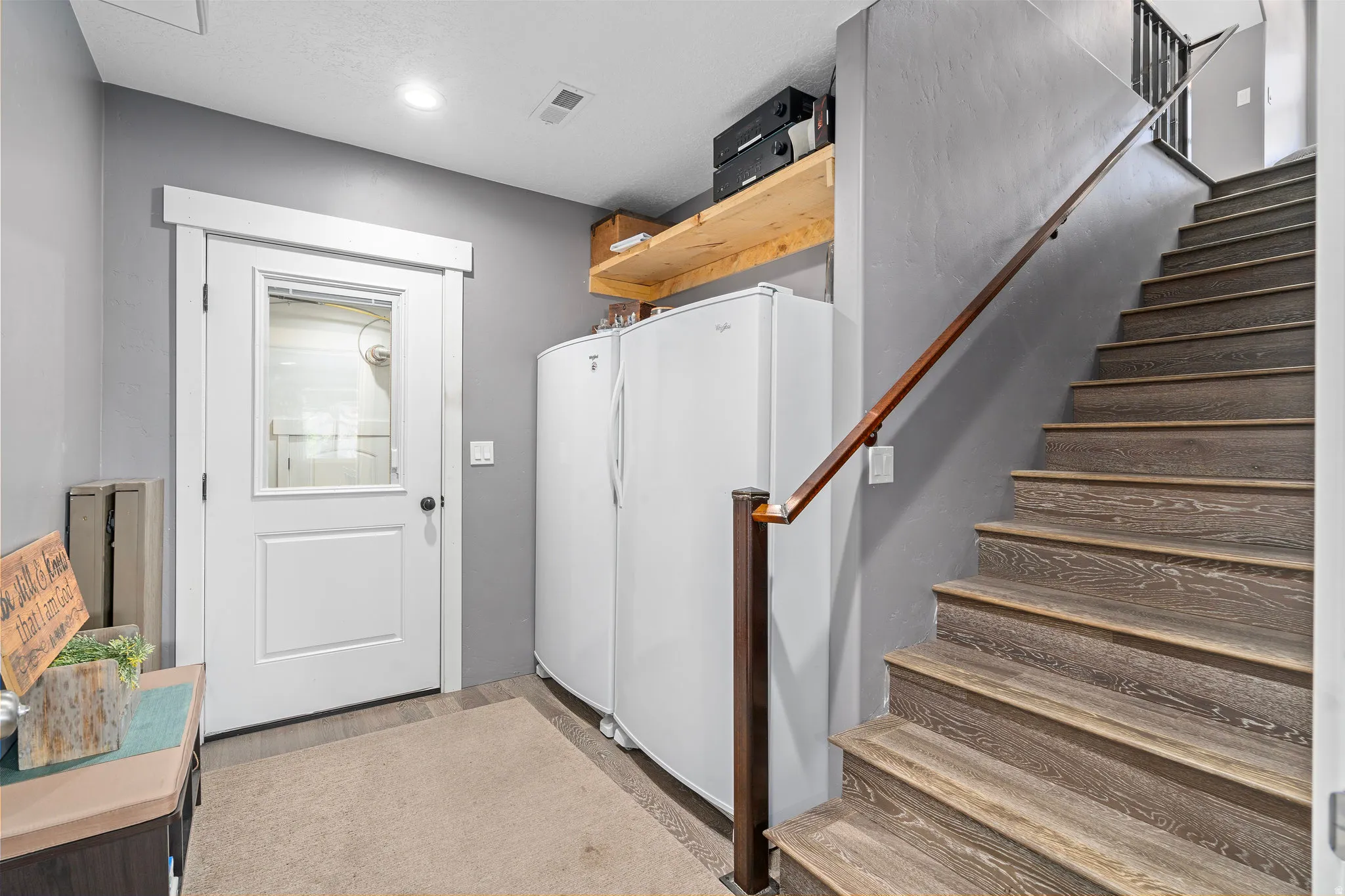 Laundry room featuring light wood-style floors