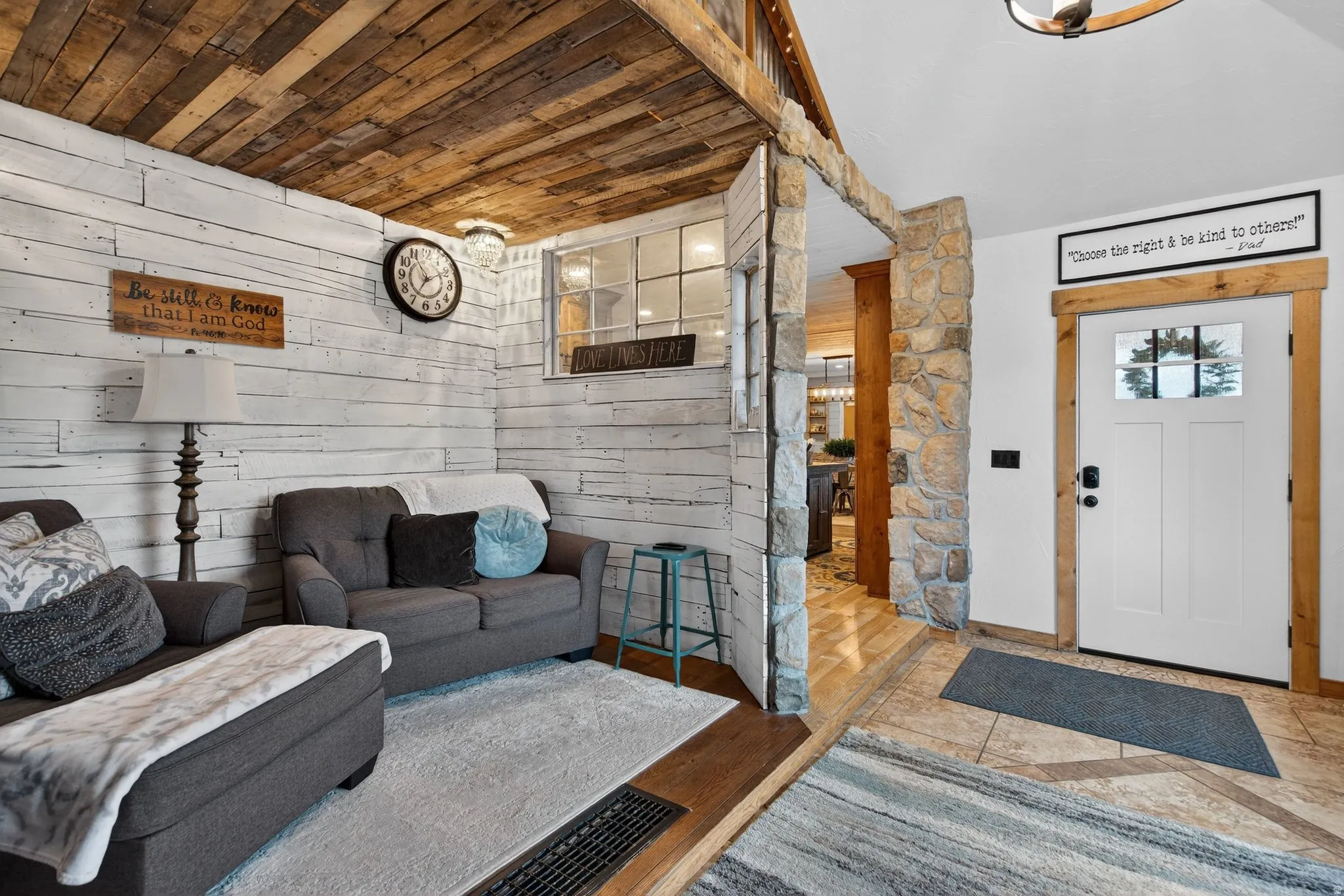 Living room featuring wood walls and wooden ceiling