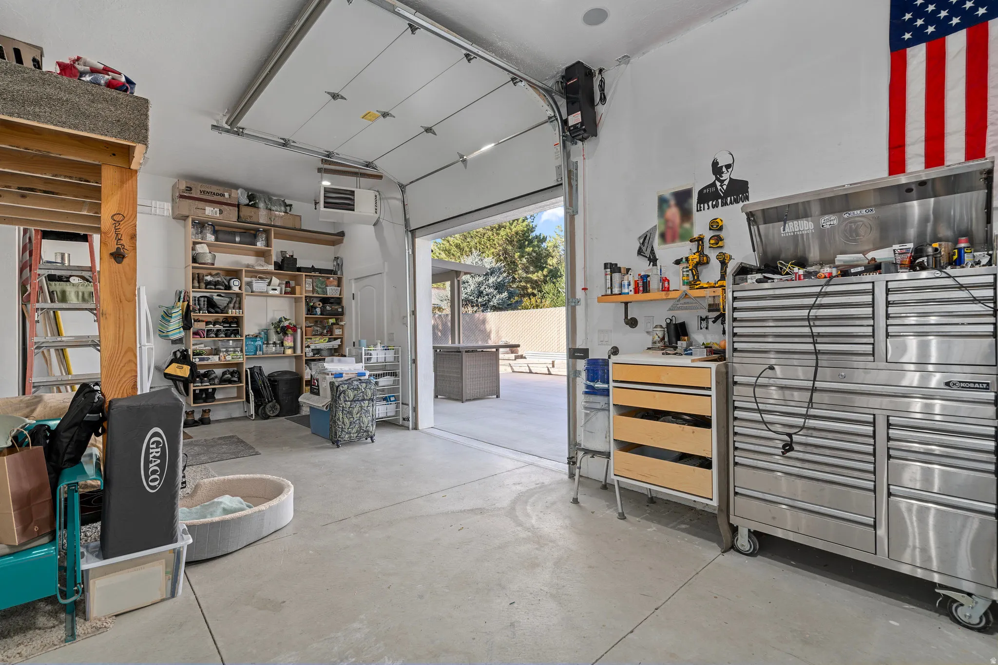 Garage featuring a heating unit and a workshop area