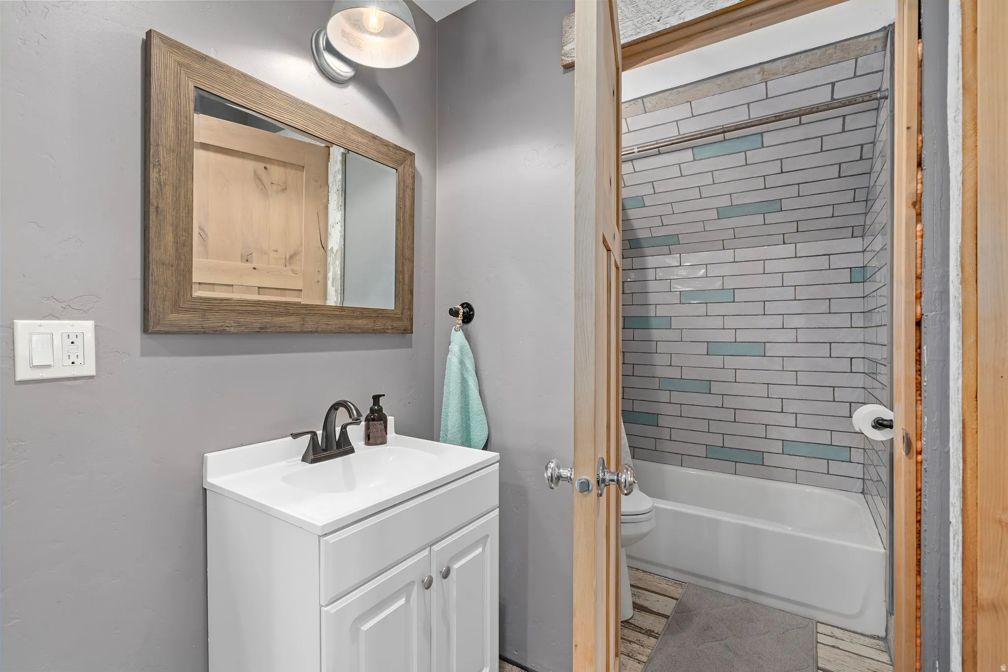 Bathroom with vanity and tub / shower combination