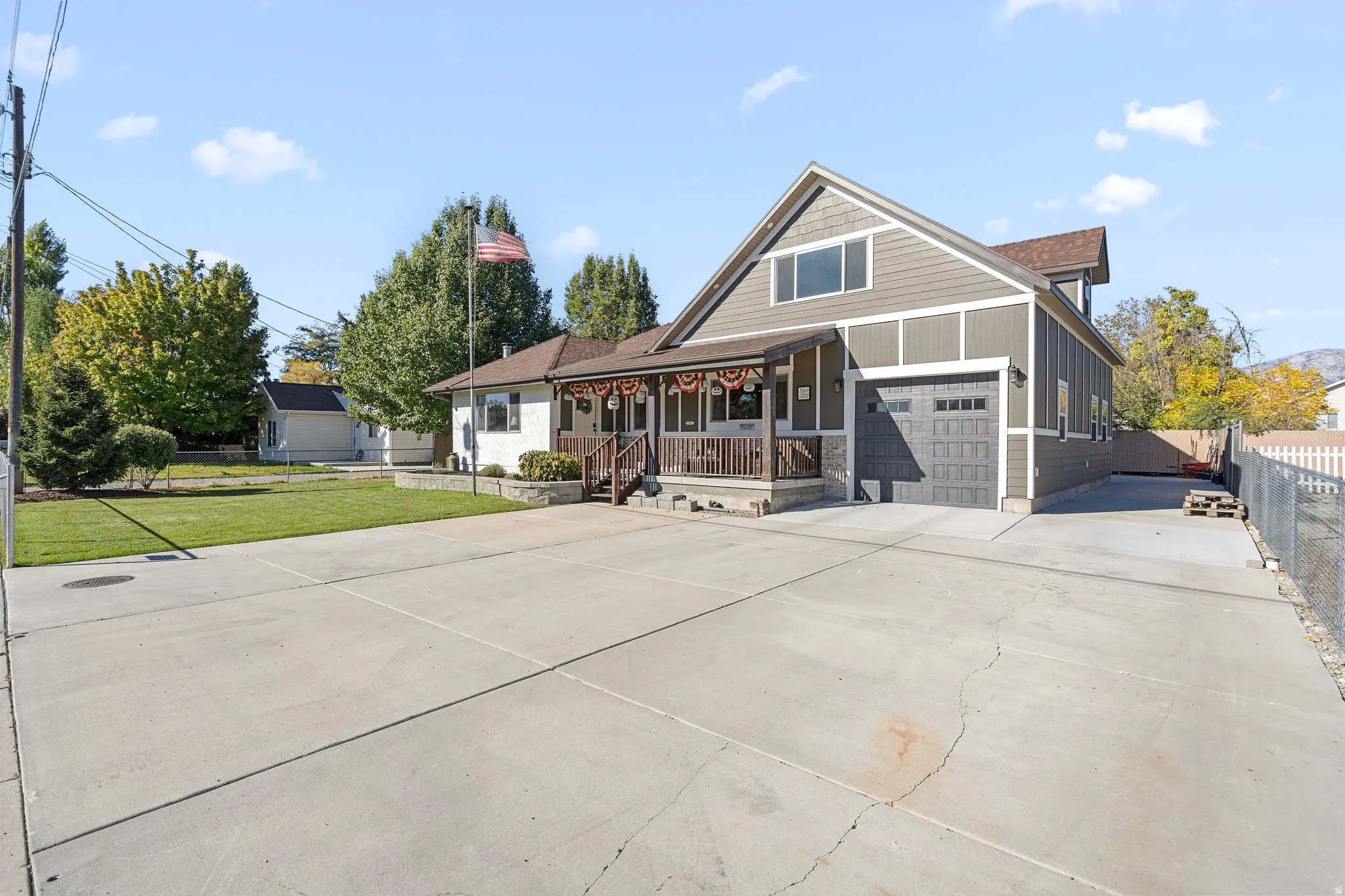 View of front facade with concrete driveway and a porch
