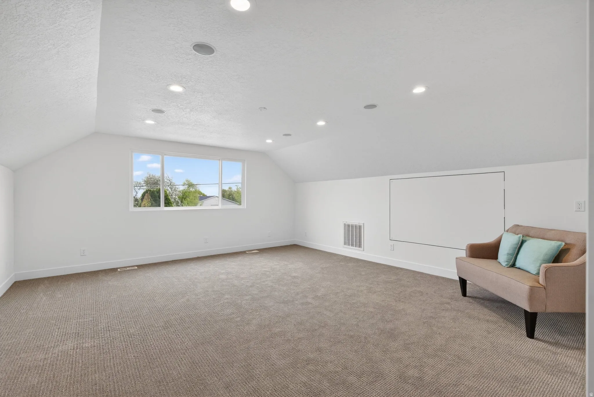 Bonus room featuring carpet, a textured ceiling, and recessed lighting