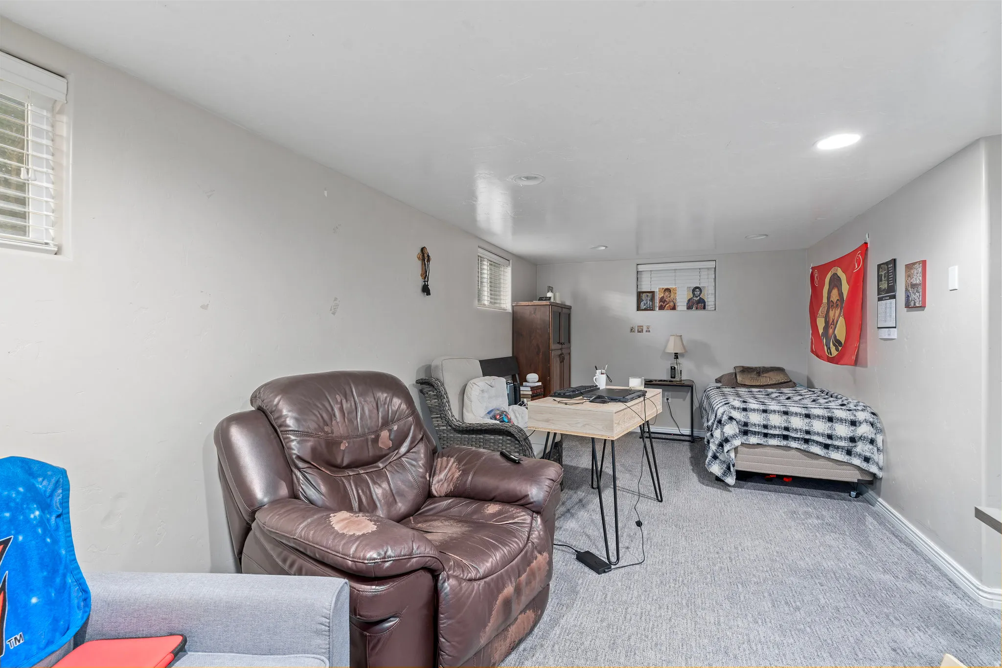 Living area featuring light colored carpet and baseboards