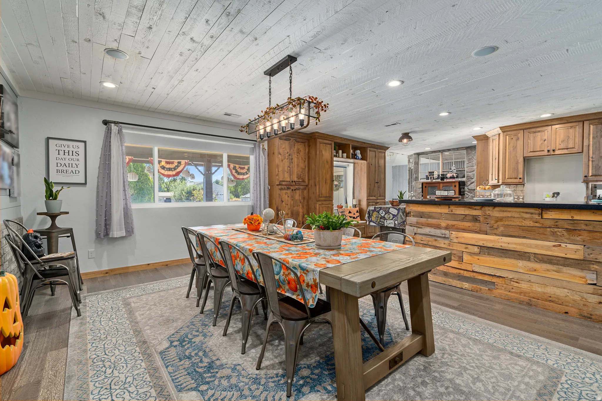 Dining room with wood finished floors, recessed lighting, and wood ceiling