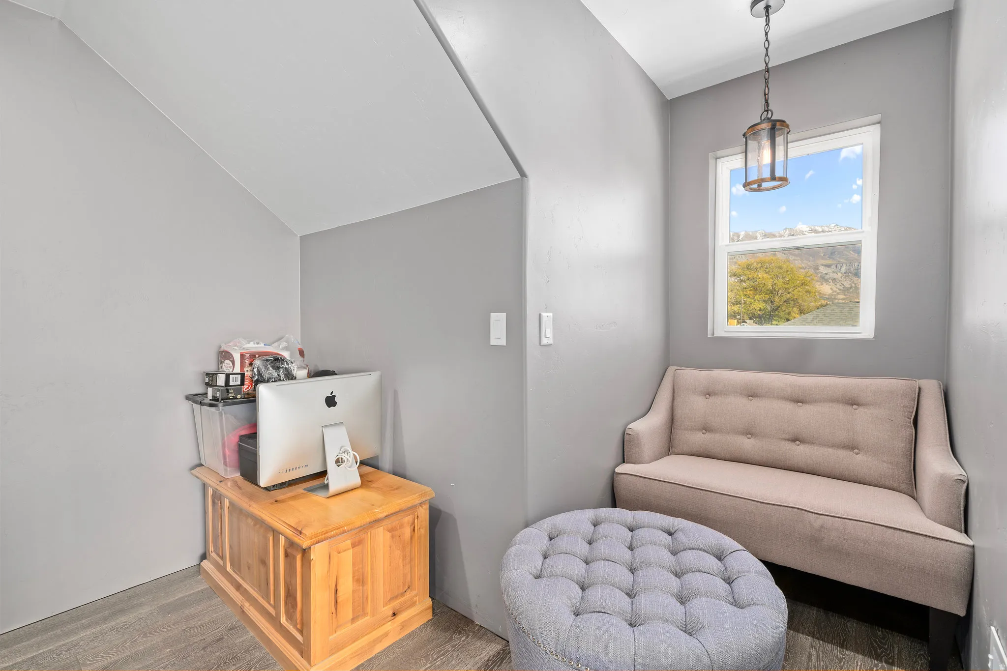 Living area featuring wood finished floors and lofted ceiling