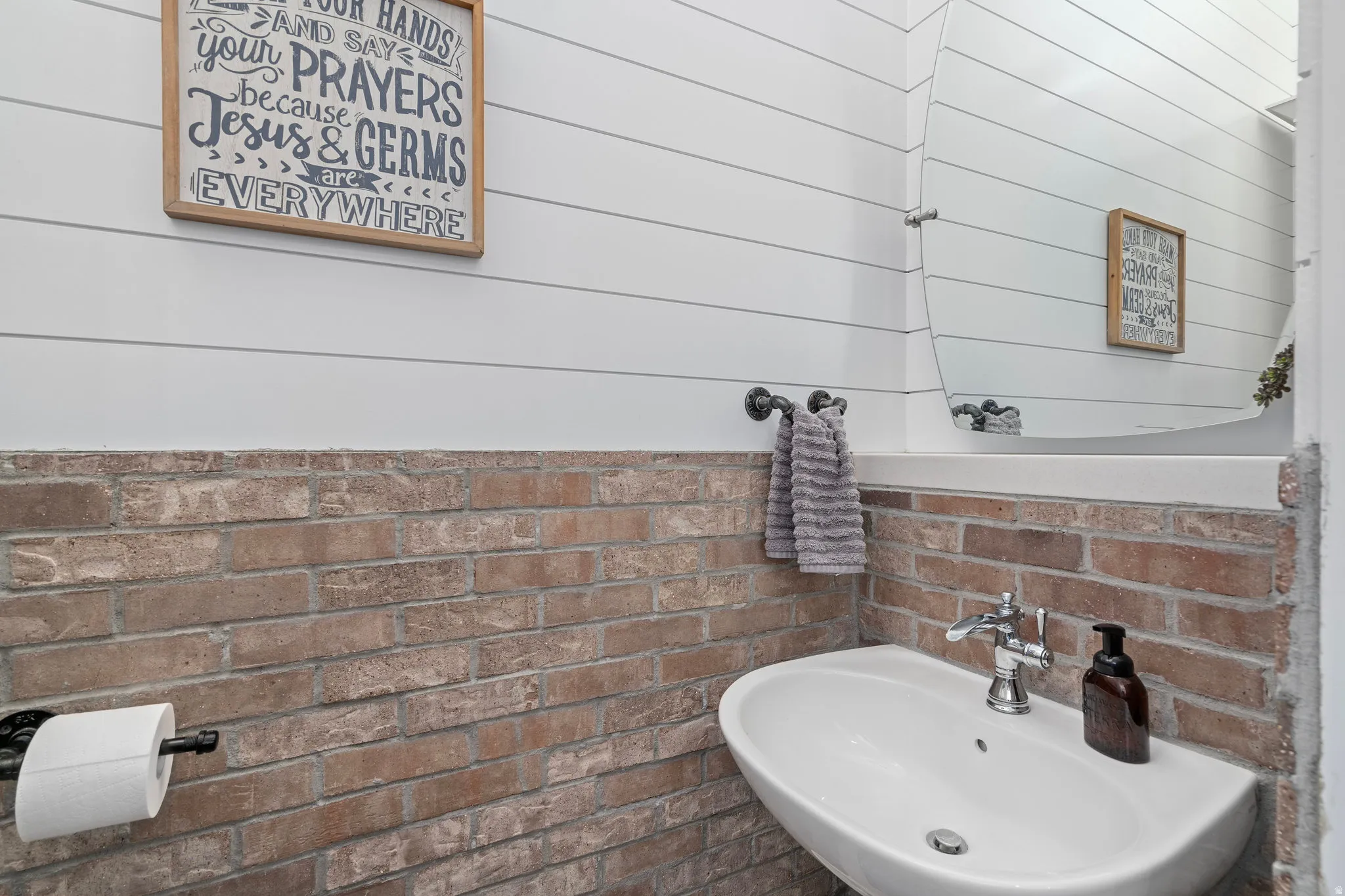 Bathroom featuring a wainscoted wall and tile walls