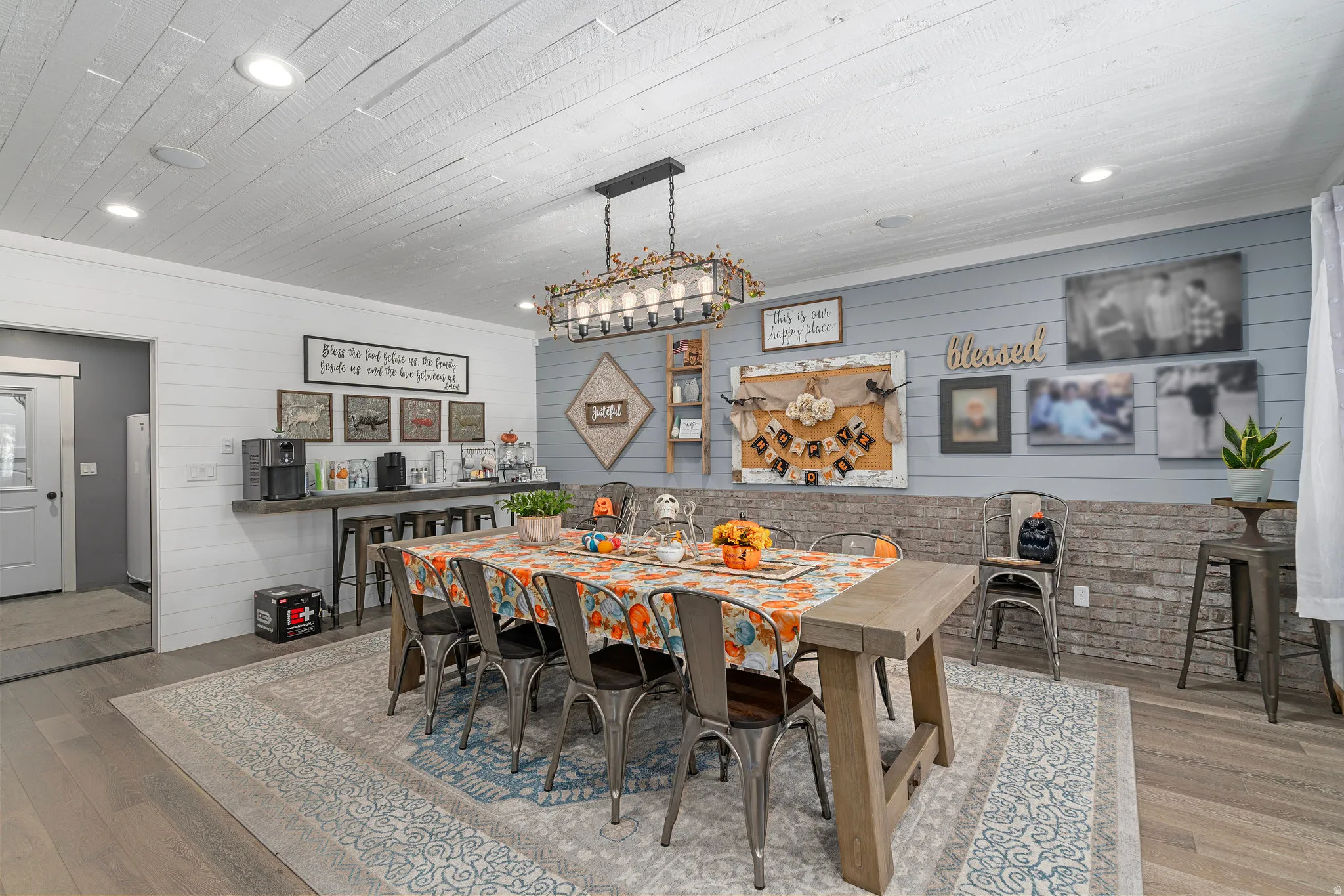 Dining room featuring hardwood / wood-style flooring, recessed lighting, and wood walls