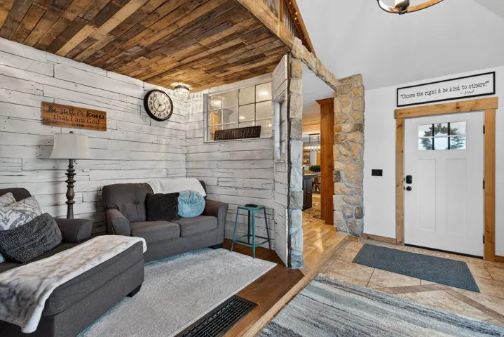 Living room featuring wood walls and wooden ceiling