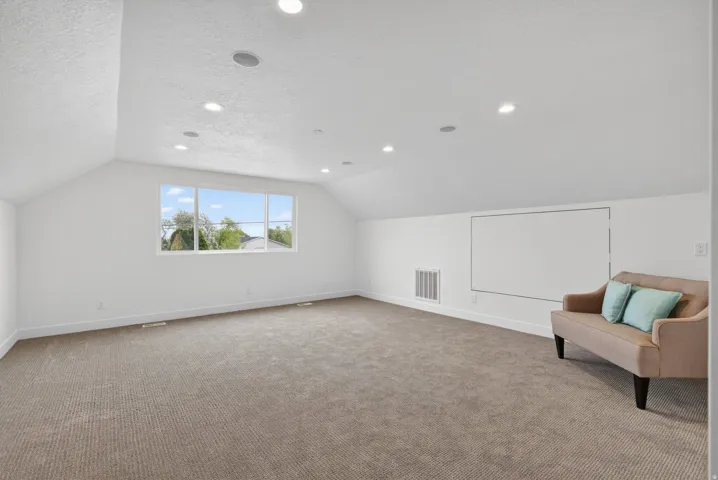 Bonus room featuring carpet, a textured ceiling, and recessed lighting