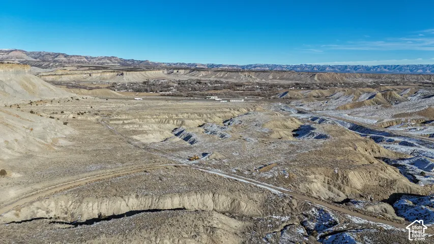 Aerial view of sparsely populated area with mountains and a desert landscape