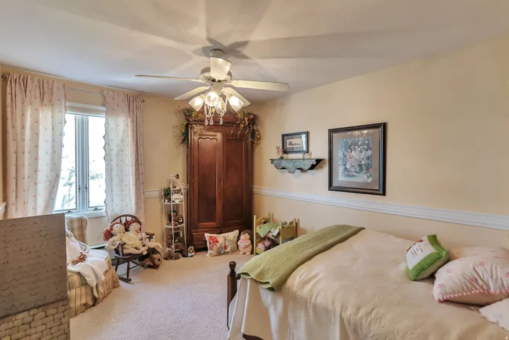 Bedroom featuring carpet and ceiling fan