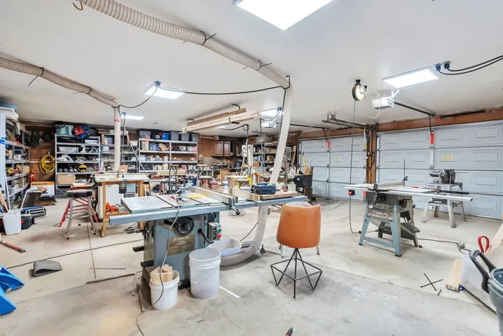 Garage with a workshop area and a garage door opener