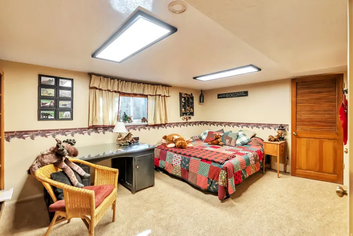 Bedroom featuring light colored carpet