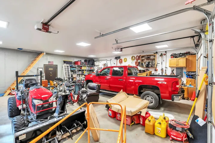 Detached garage featuring a garage door opener, electric panel, heated garage and secure vault.