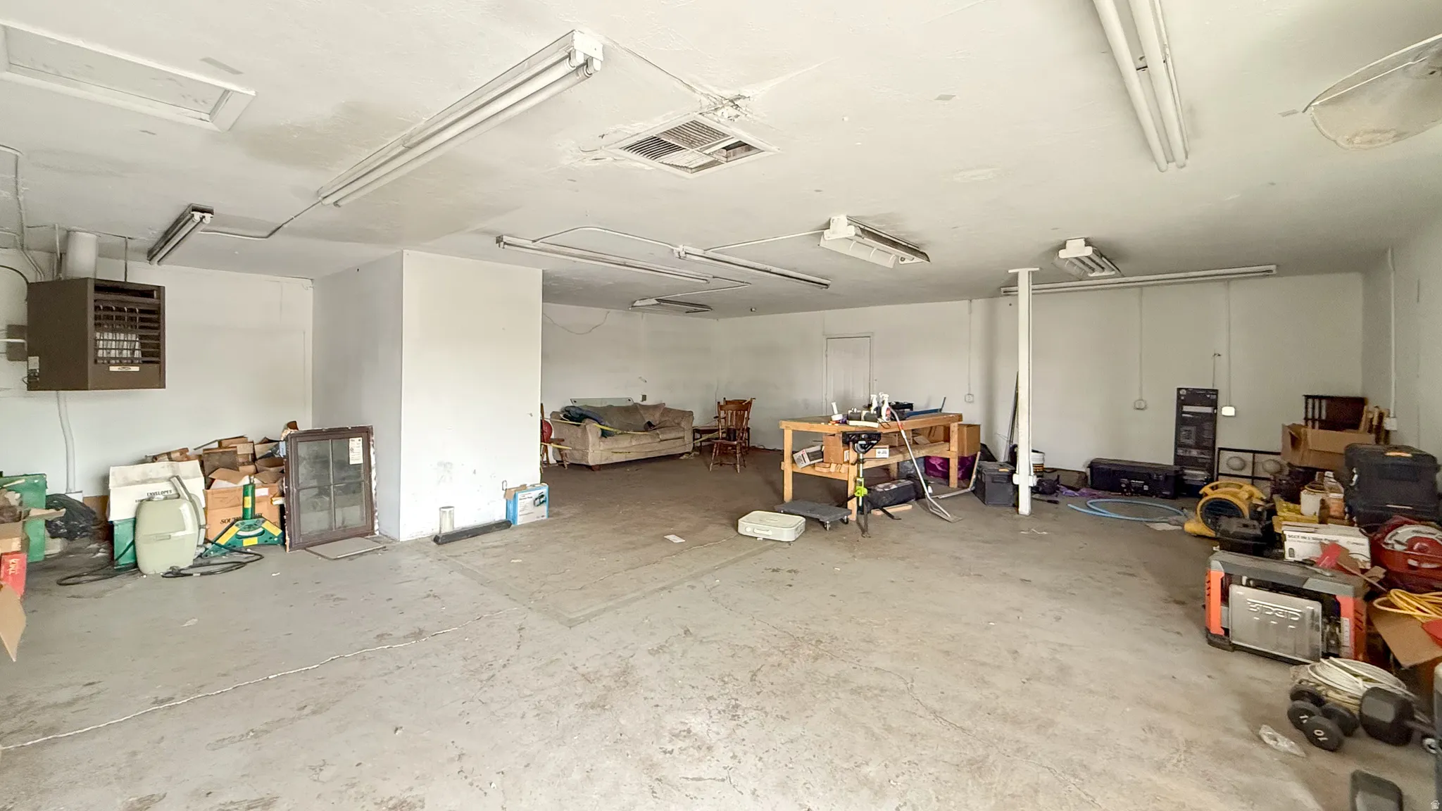 Garage featuring a heating unit