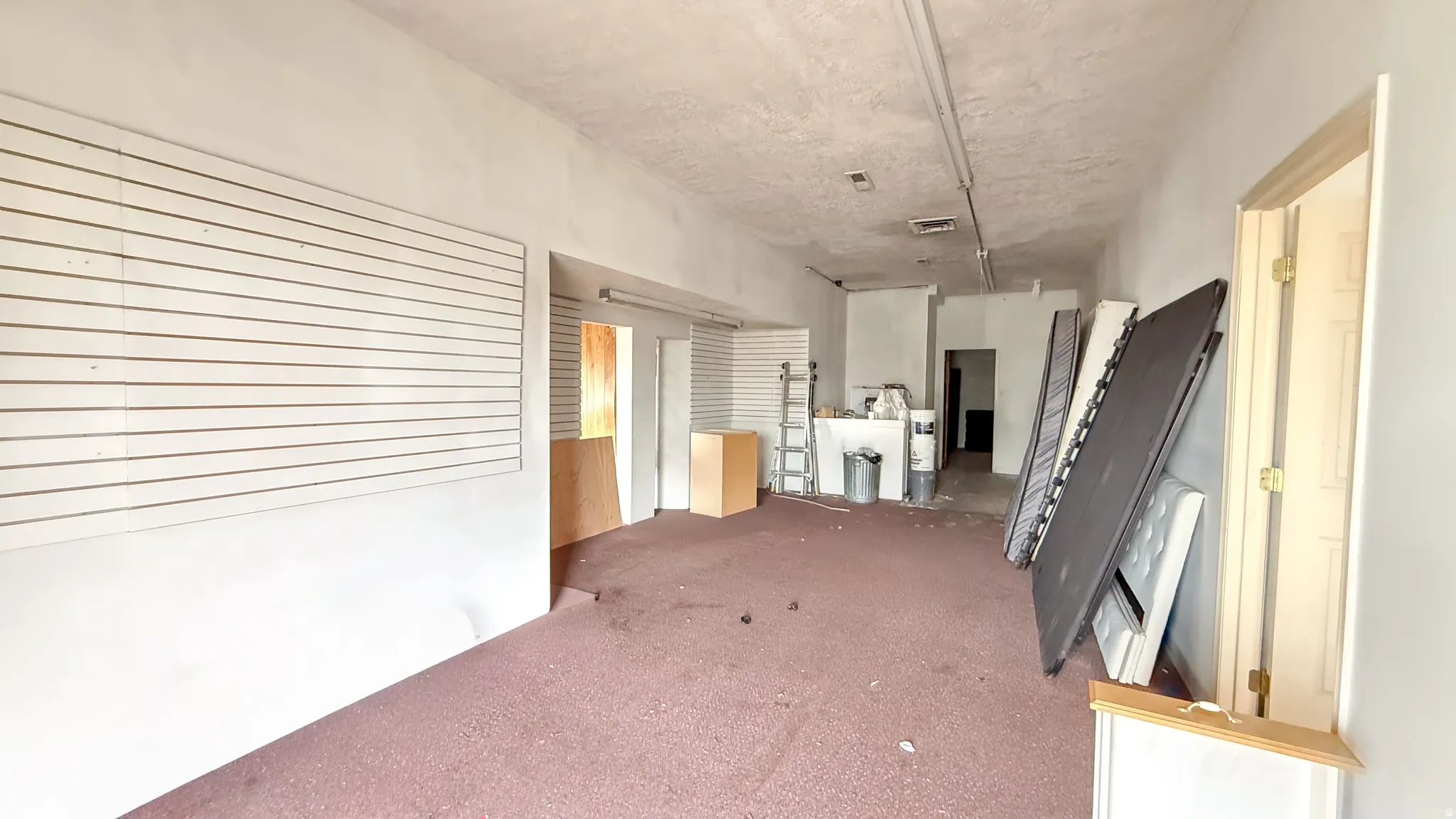 Corridor featuring carpet flooring