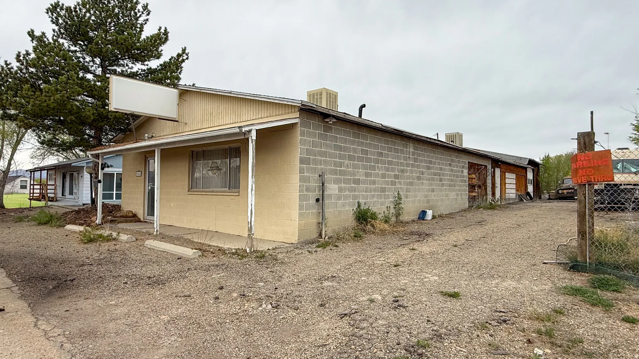 View of side of home with concrete block siding and a cooling unit