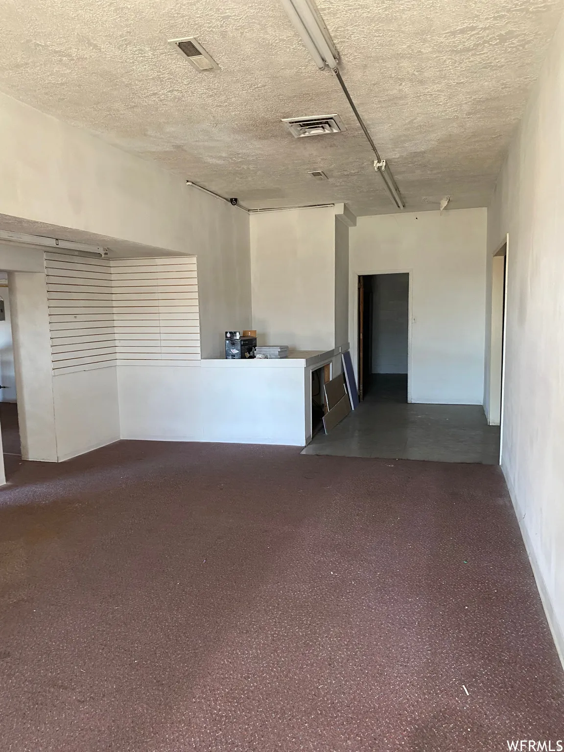 Empty room featuring a textured ceiling