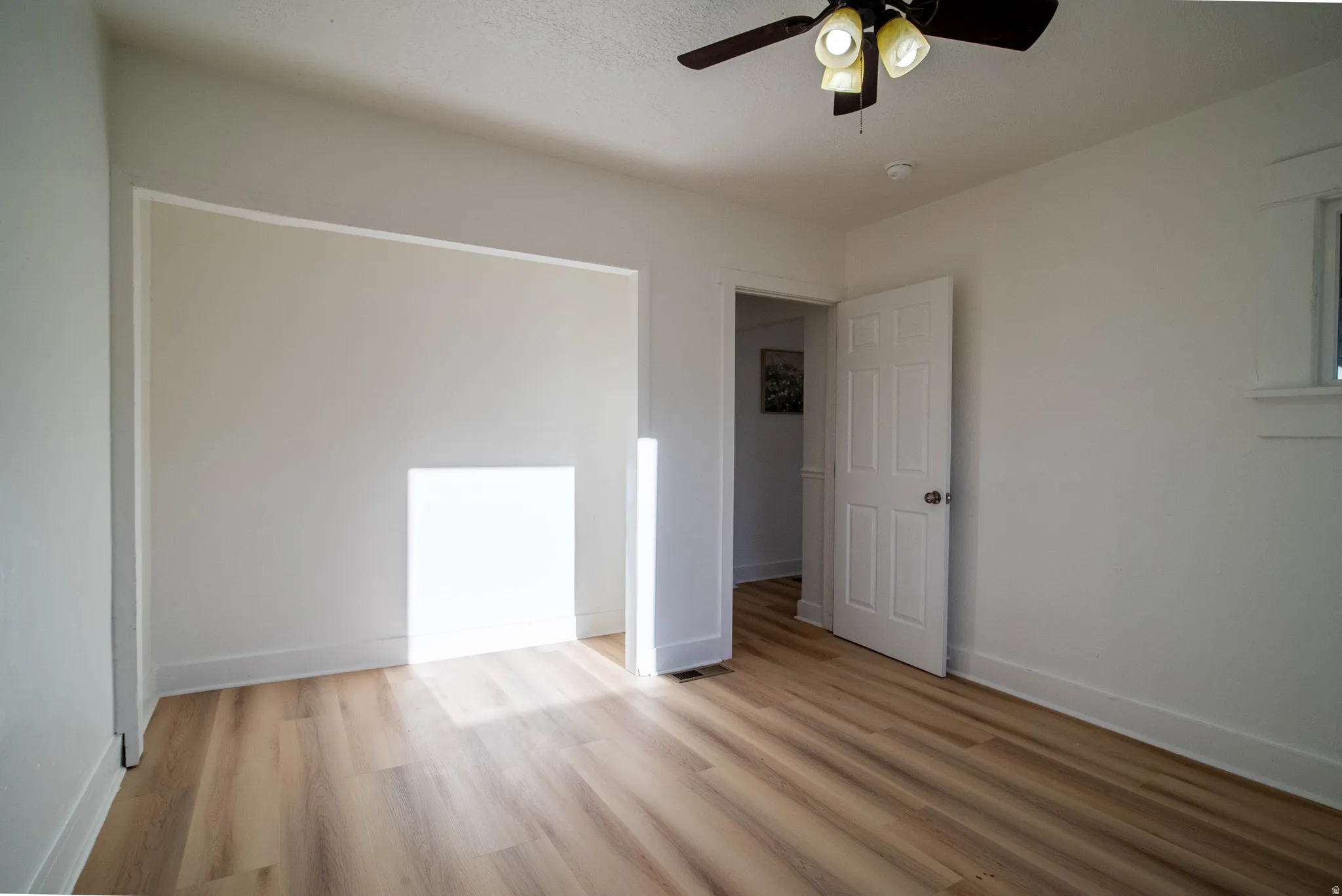 Unfurnished bedroom featuring light wood-style flooring and a ceiling fan