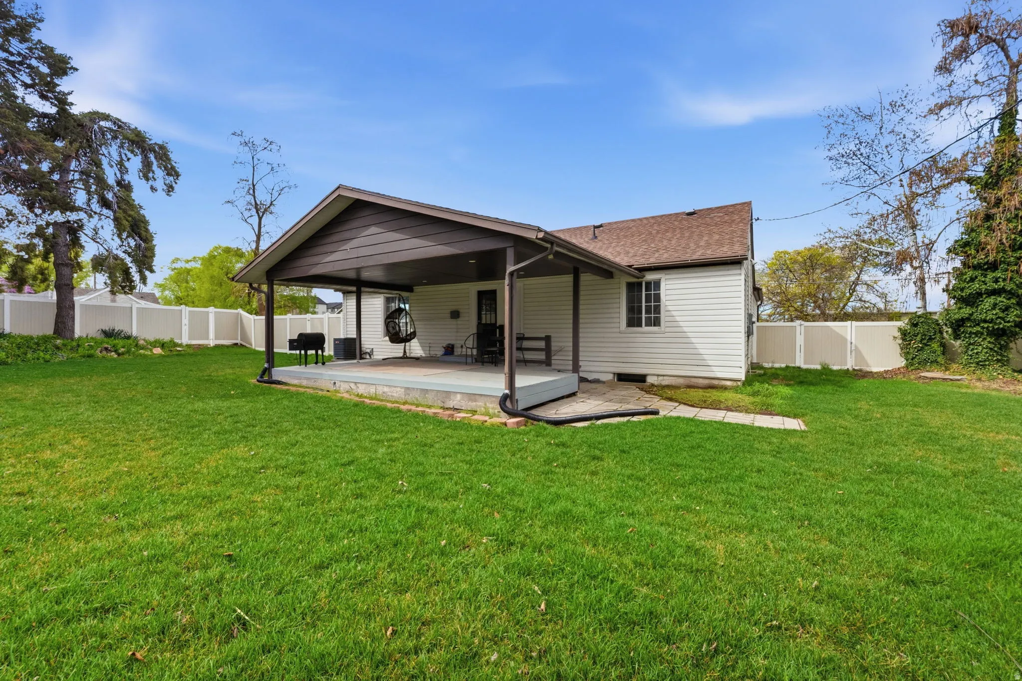 Back of property featuring a fenced backyard, crawl space, roof with shingles, and a wooden deck