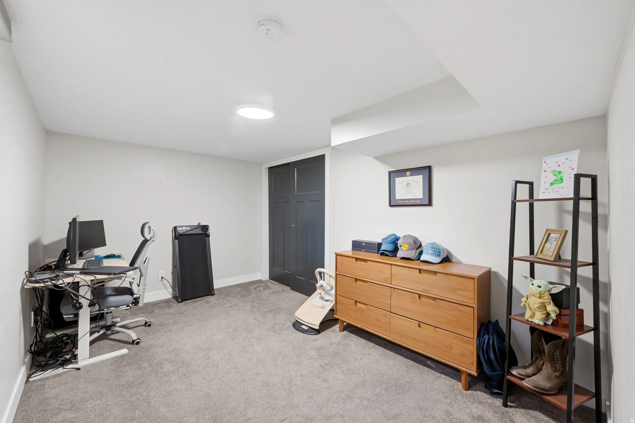 Office area featuring light carpet and baseboards