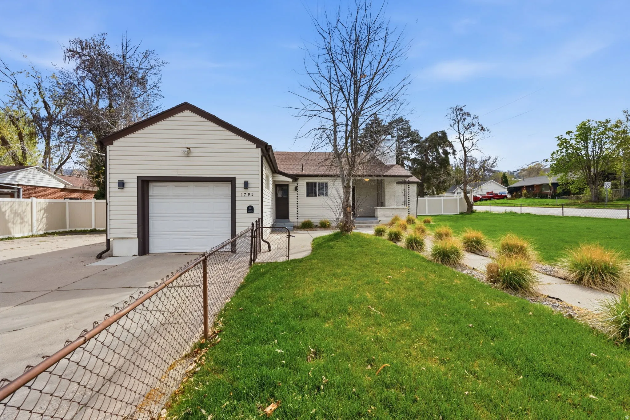 Single story home featuring an attached garage and driveway