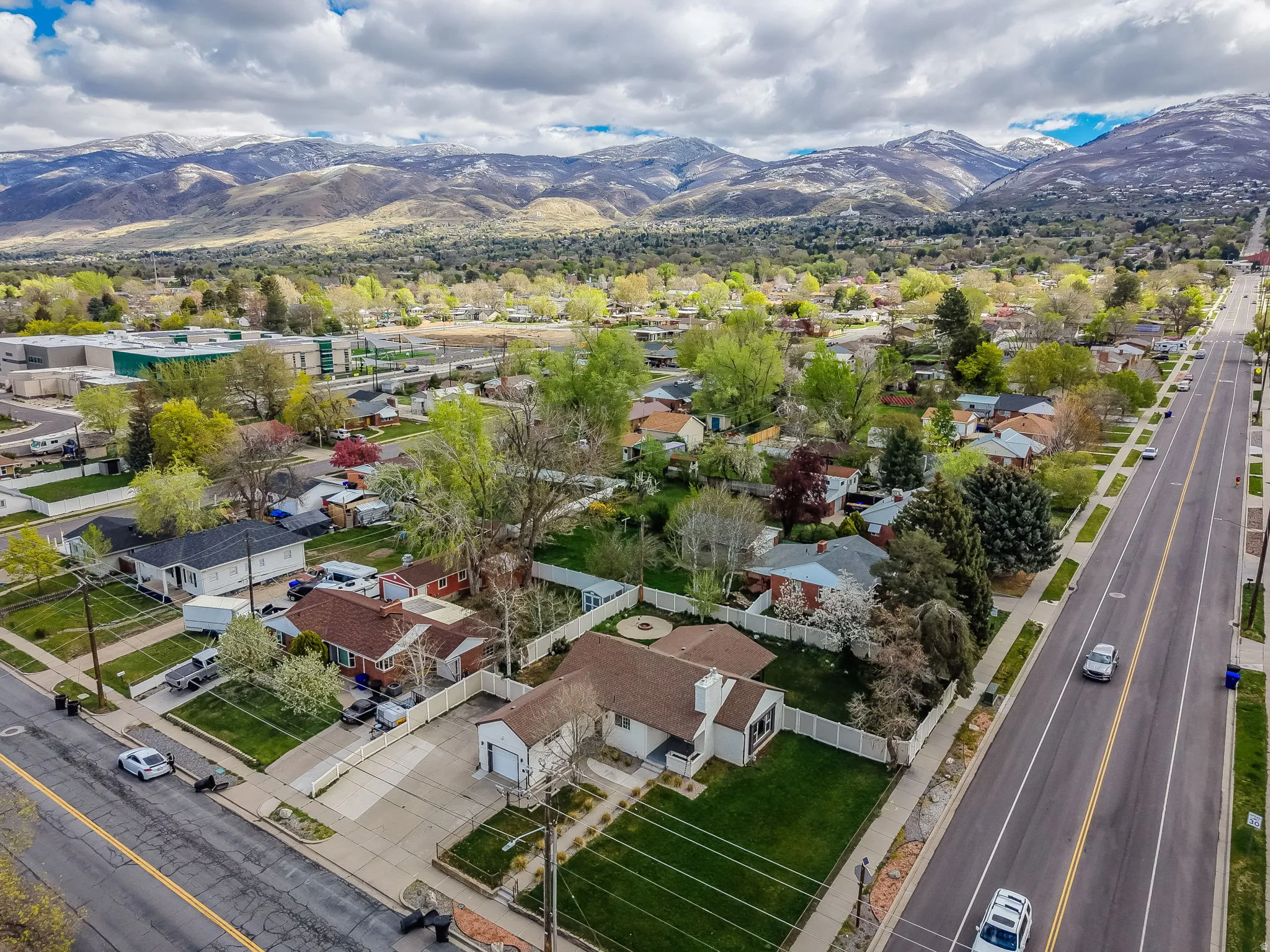 Aerial perspective of suburban area featuring a mountain backdrop
