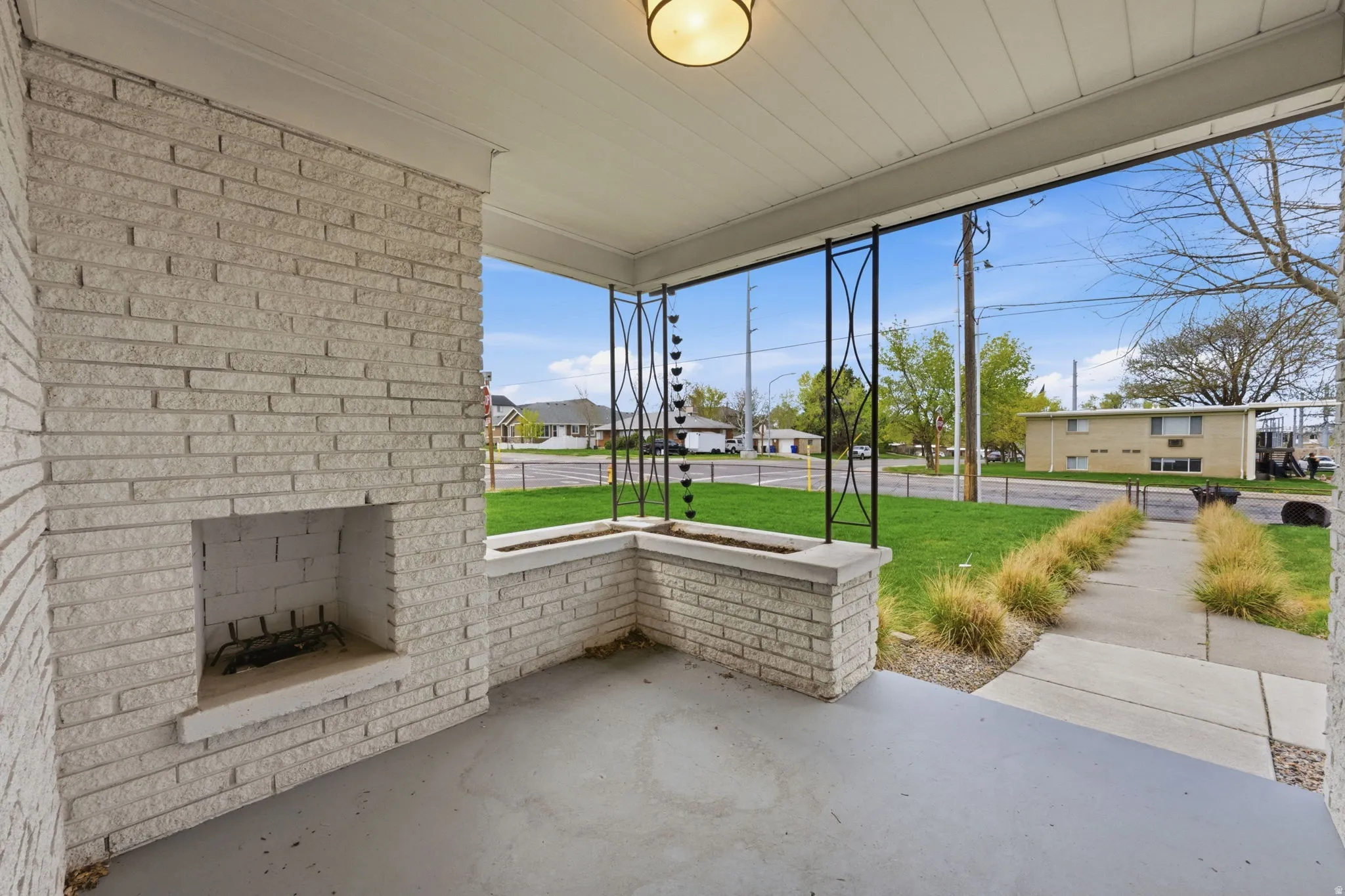 Covered porch with a residential view and a lawn