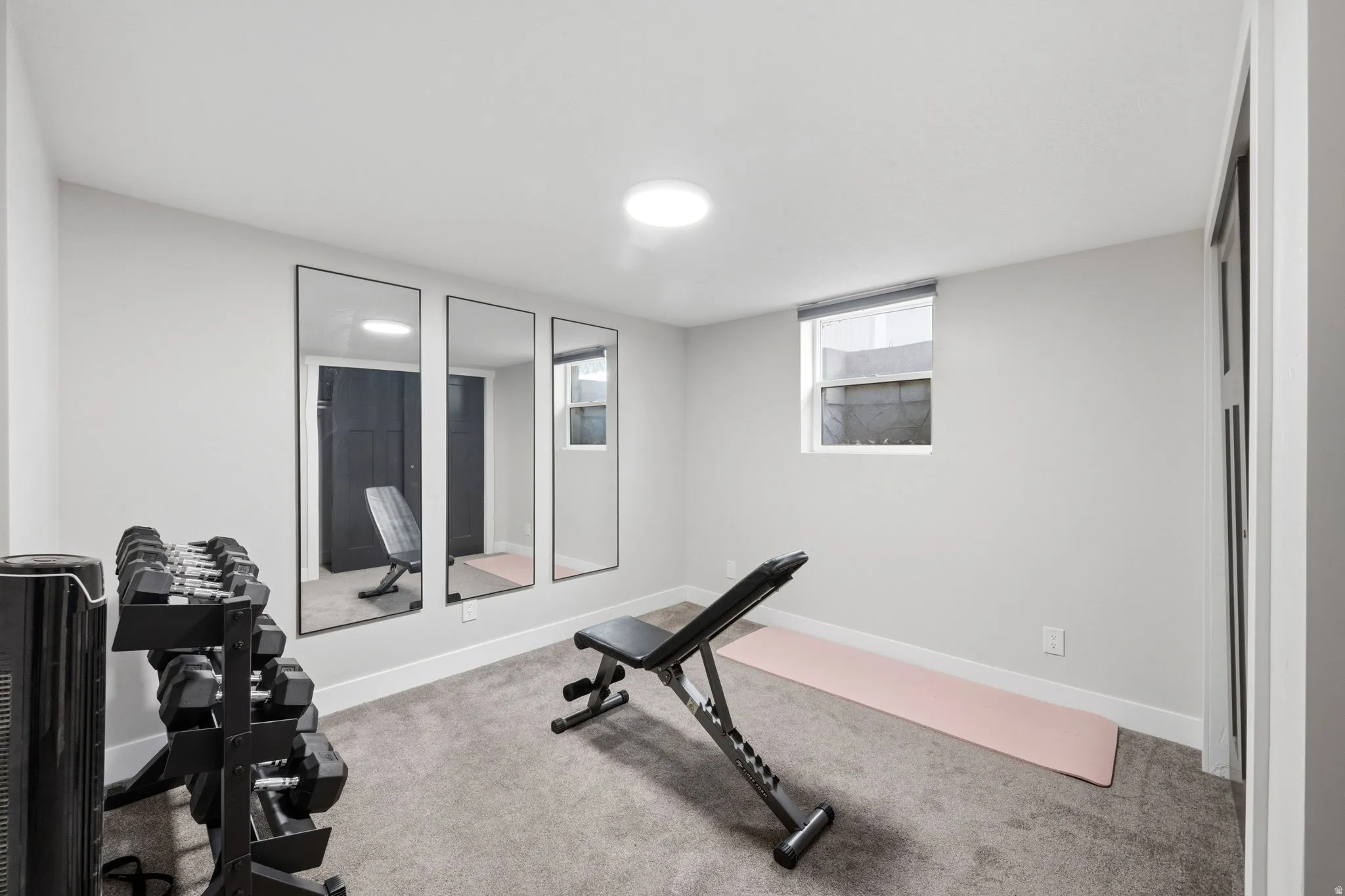 Exercise room featuring light colored carpet