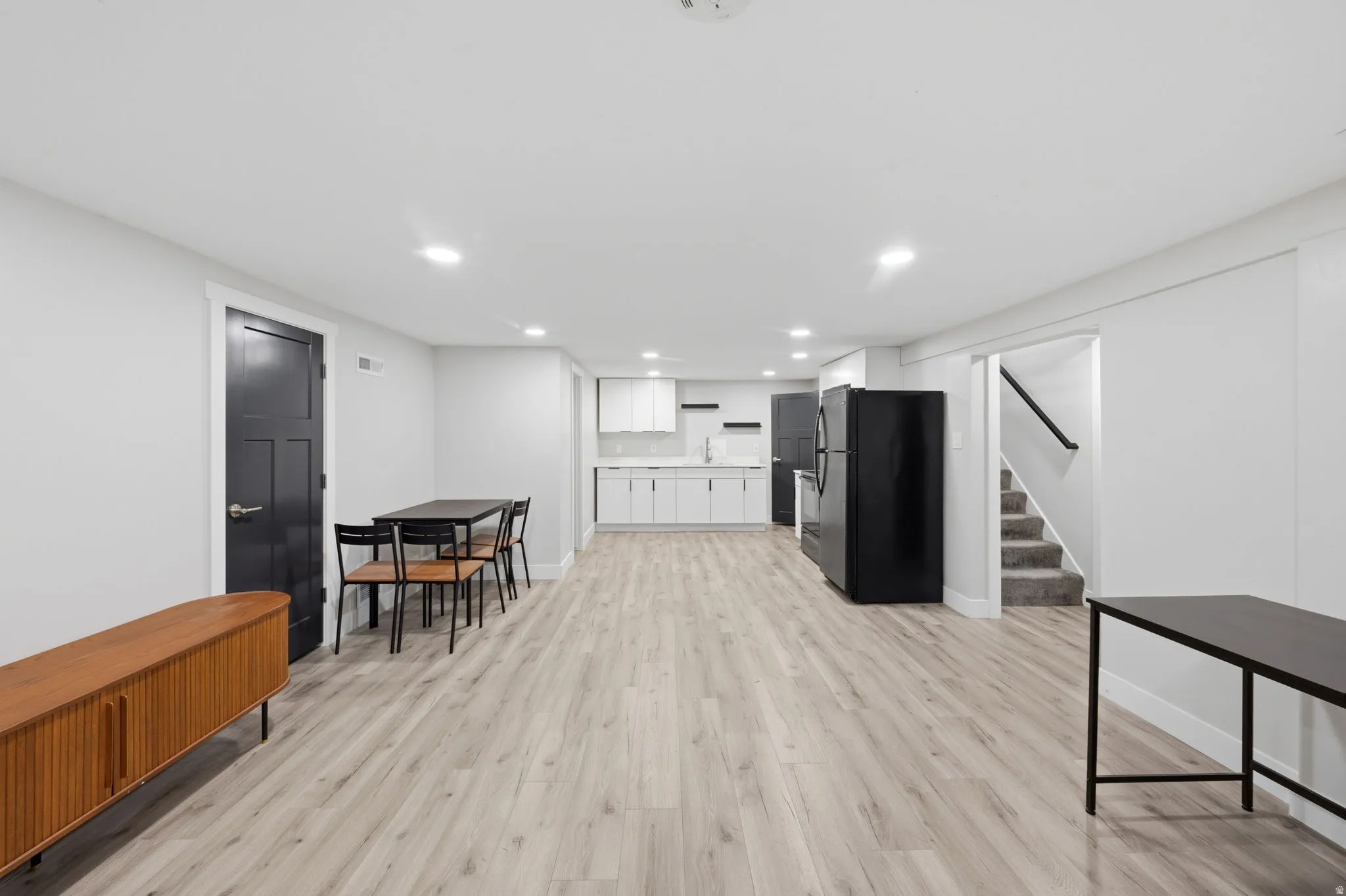 Living room featuring light wood-style floors and recessed lighting