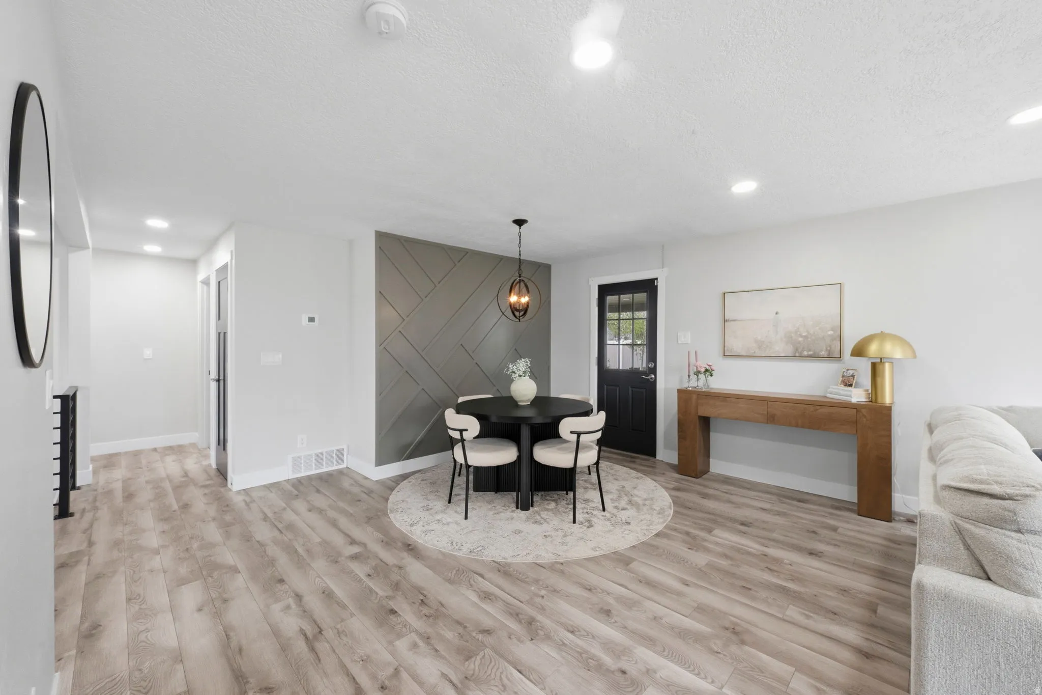Dining space featuring light wood-style flooring, a textured ceiling, and recessed lighting