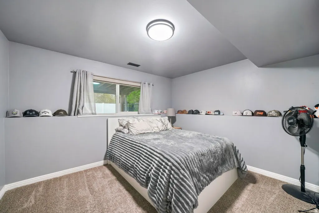 Downstairs bedroom with a nice shelf and neutral paint