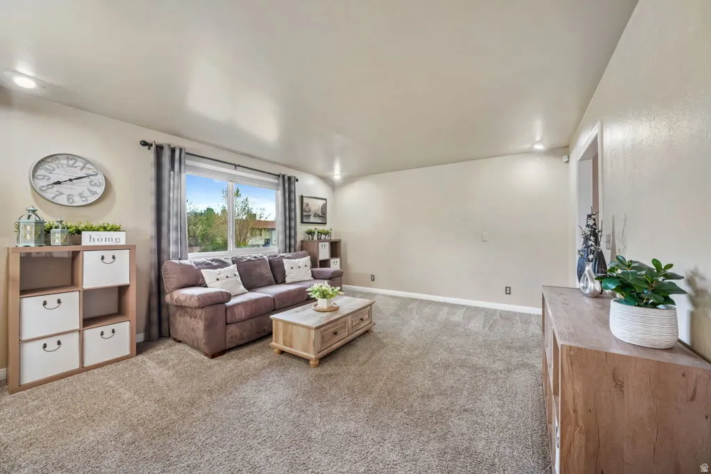 Another shot of the Living room with light carpet, nice open area to spend family time, next to the GAME ROOM.