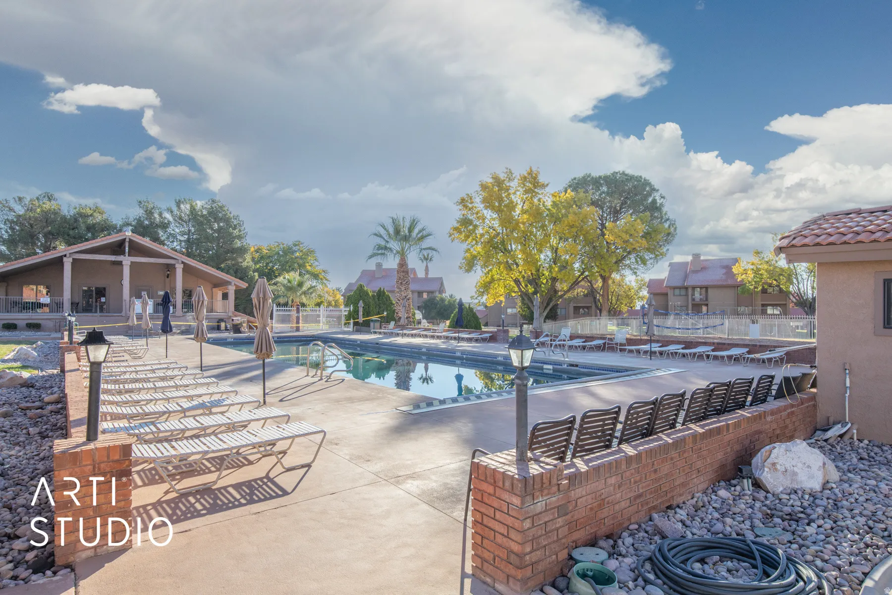 Community pool with a patio