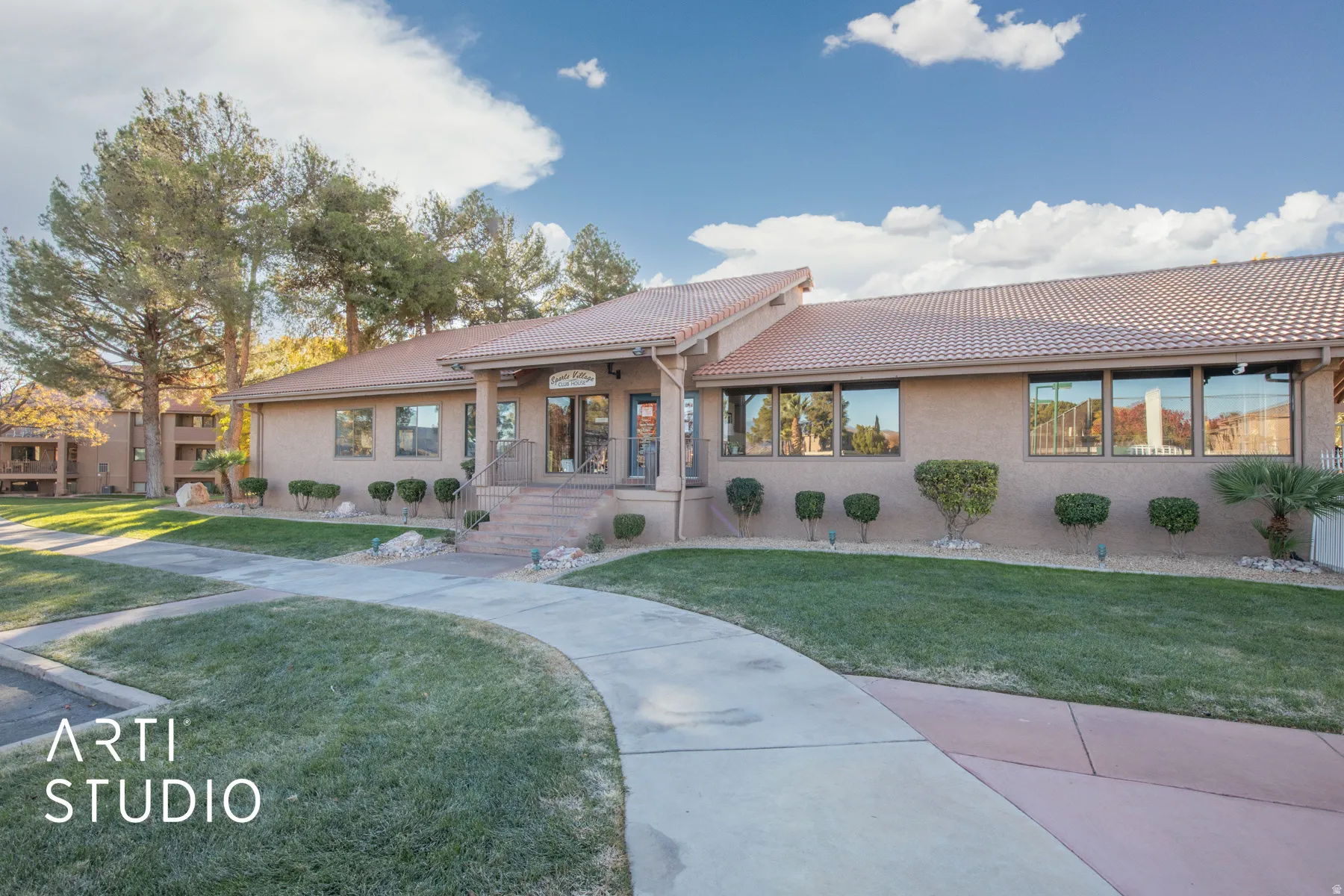 Mediterranean / spanish home with stucco siding, a tiled roof, and a front lawn